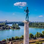 a statue of a man standing on top of a tower